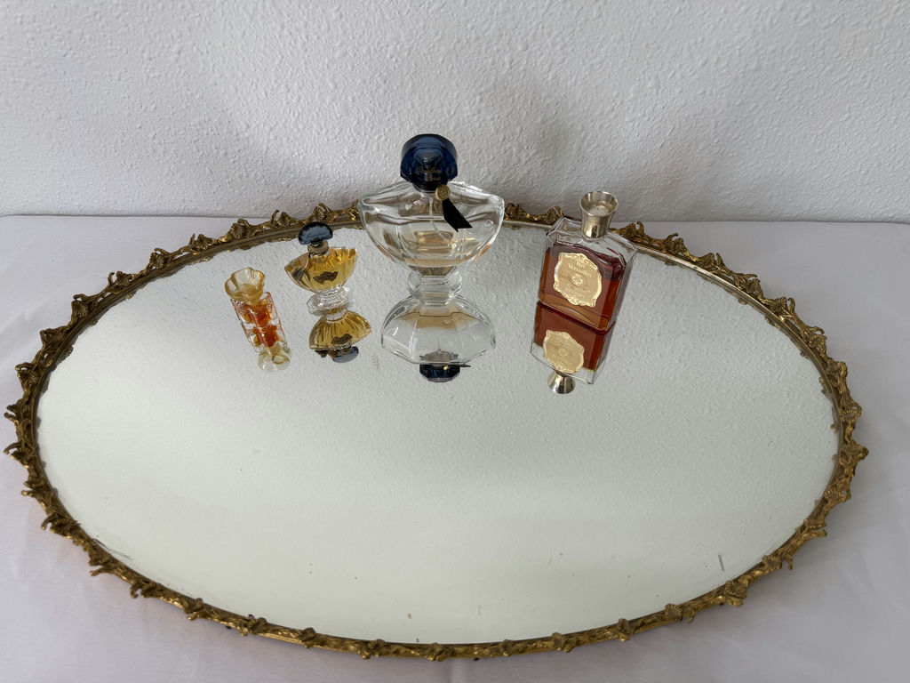 Oval gilt-mild mirror with vintage perfume bottles and decorative folding fans - image 2 of 5