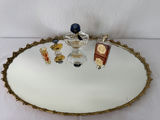 Oval gilt-mild mirror with vintage perfume bottles and decorative folding fans - thumbnail 2 of 5