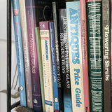 Metal and Wicker Shelving Unit with Books and Decorative Items - thumbnail 16 of 19