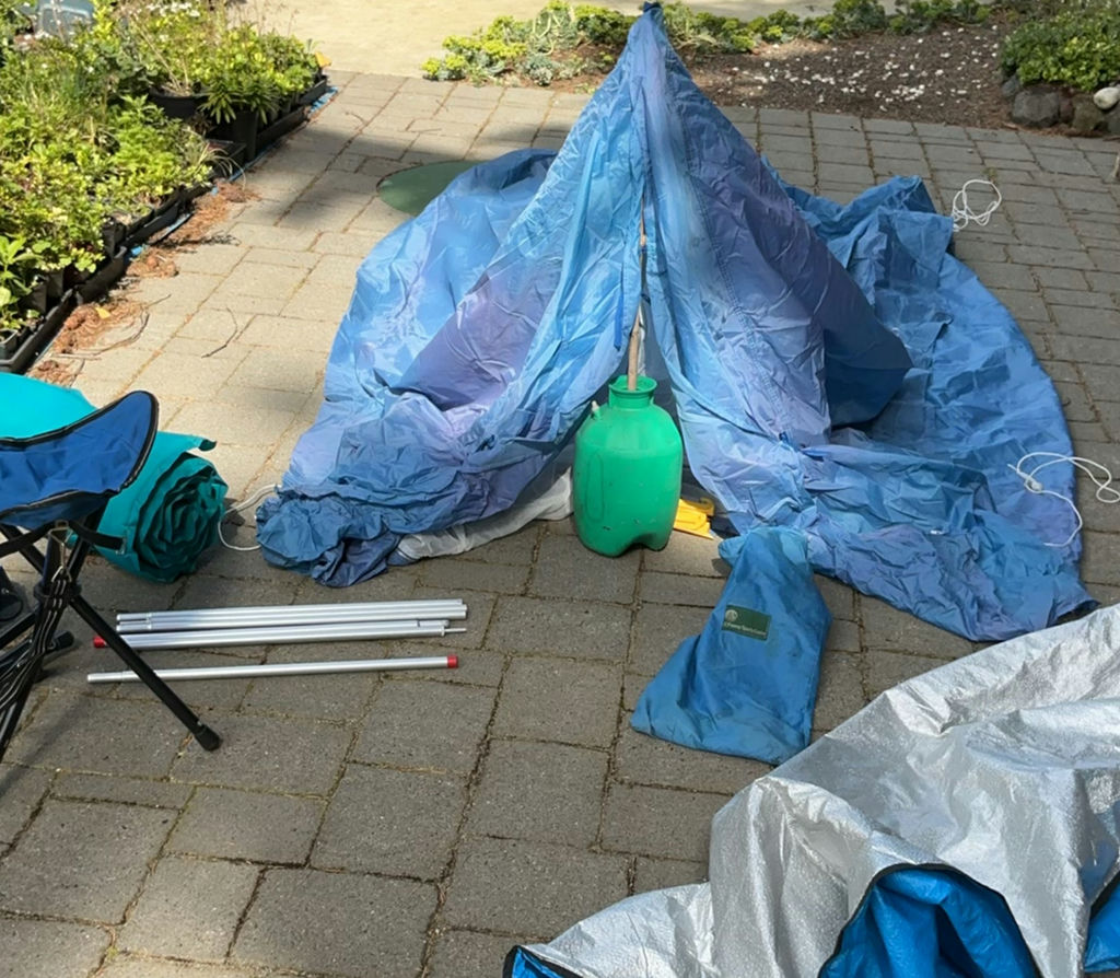 Camping Tent Setup with Poles and Gear - image 1 of 9