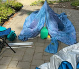 Camping Tent Setup with Poles and Gear - thumbnail 1 of 9