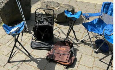 Blue folding camping chairs, trekking poles, and brown backpack - Image 1 of 7