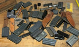 Assorted firearm magazines, holsters, and ammo box - thumbnail 1 of 7