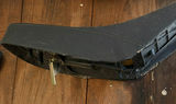 Assorted household items: box, curved plastic component with latch, bin of red and yellow straps, and towel - thumbnail 2 of 5