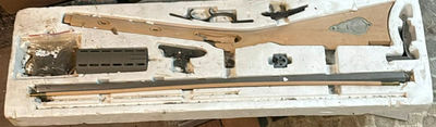 Disassembled firearm parts with wooden stocks and metal components - Image 1 of 5