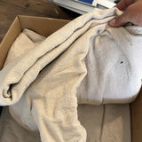 Assorted household items: box, curved plastic component with latch, bin of red and yellow straps, and towel - thumbnail 5 of 5