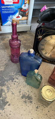 Assorted colored glass bottles and a clock - Image 1 of 6