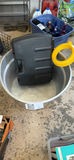 Black hard-shell protective case inside a metal tub with lawn sprinkler - thumbnail 1 of 2