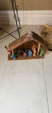 Assorted Christmas decorations: artificial evergreen tree with burlap ribbon, pinecones, poinsettia, nativity display, and cone sculptures - thumbnail 5 of 5