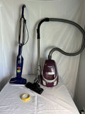 Panasonic Purple HEPA Canister Vacuum and Blue Bissell 3-way Bagless Vacuum with Attachments - thumbnail 1 of 6