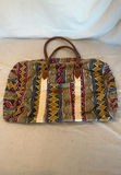 Three travel bags: blue sports duffel, black/green duffel, and patterned weekend bag - thumbnail 4 of 5