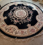 Round wool rug with central medallion and floral border - thumbnail 1 of 3