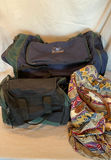 Three travel bags: blue sports duffel, black/green duffel, and patterned weekend bag - thumbnail 1 of 5