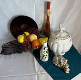 Still-life arrangement with ceramic tureen, fruit basket, and decorative bottles - thumbnail 1 of 4