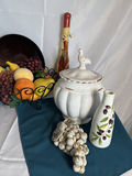 Still-life arrangement with ceramic tureen, fruit basket, and decorative bottles - thumbnail 3 of 4