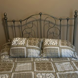 Ornate metal bed frame with quilted bedding - thumbnail 2 of 6