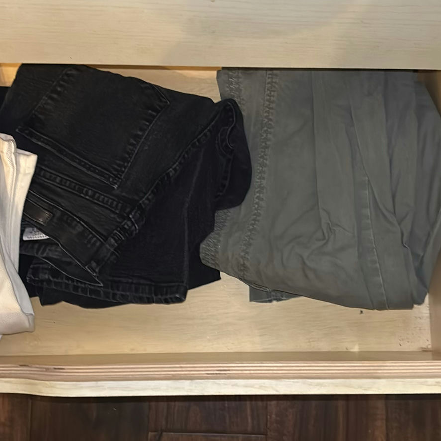 Assorted pants and jeans in a dresser drawer - image 4 of 6