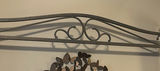 Cream four-poster bed with wrought-iron headboard and circular wall art - thumbnail 9 of 11