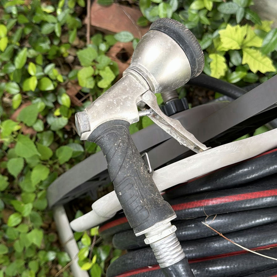 Wheeled garden hose reel with coiled hose - image 3 of 4