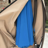 Beige folded patio umbrella with blue interior canopy on round base - thumbnail 3 of 5