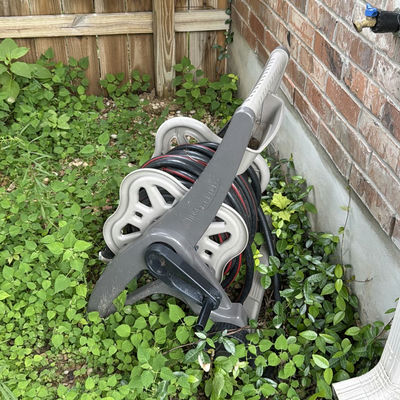 Wheeled garden hose reel with coiled hose - Image 1 of 4