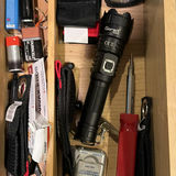 Assorted tools, adhesives, and maintenance supplies in a wooden organizer - thumbnail 2 of 5