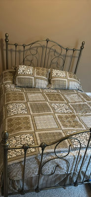 Ornate metal bed frame with quilted bedding - Image 1 of 6