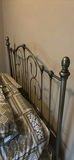 Ornate metal bed frame with quilted bedding - thumbnail 5 of 6