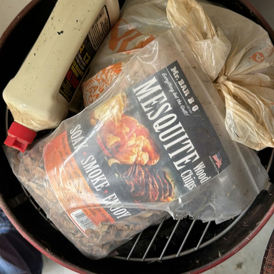 Red barrel-style smoker with wood chunks - image 4 of 5