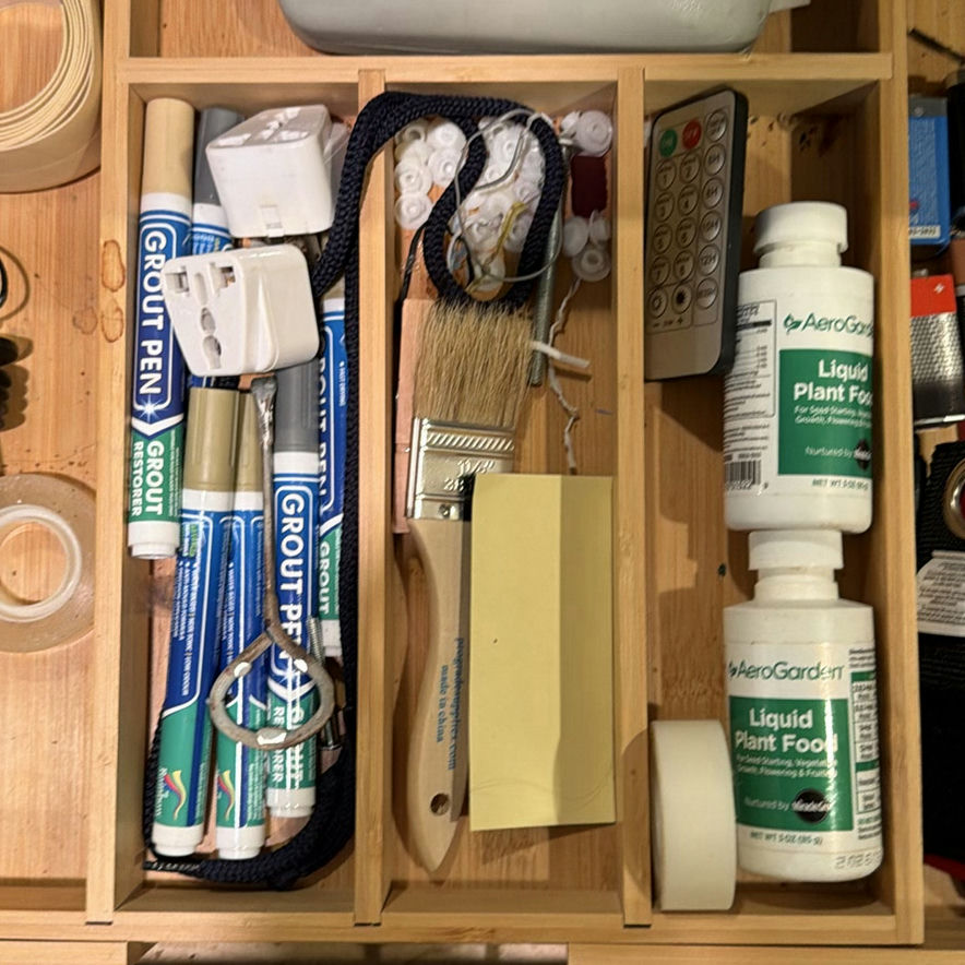 Assorted tools, adhesives, and maintenance supplies in a wooden organizer - image 3 of 5