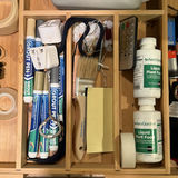 Assorted tools, adhesives, and maintenance supplies in a wooden organizer - thumbnail 3 of 5