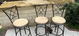 Three Black Metal Bar Stools with Beige Cushioned Seats - thumbnail 1 of 4