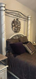 Cream four-poster bed with wrought-iron headboard and circular wall art - thumbnail 10 of 11