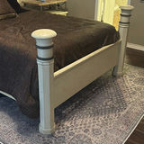 Cream four-poster bed with wrought-iron headboard and circular wall art - thumbnail 3 of 11
