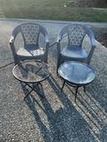 Two gray plastic patio chairs with lattice backs and two round tables (mesh and glass-top) - thumbnail 1 of 3