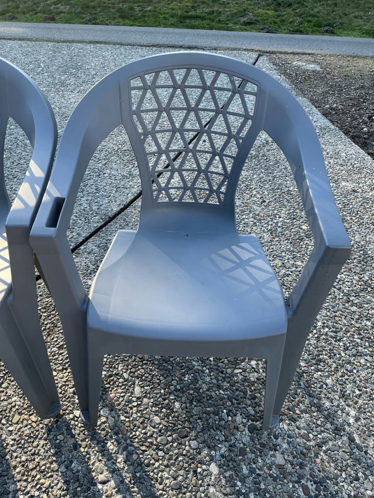 Two gray plastic patio chairs with lattice backs and two round tables (mesh and glass-top) - image 3 of 3