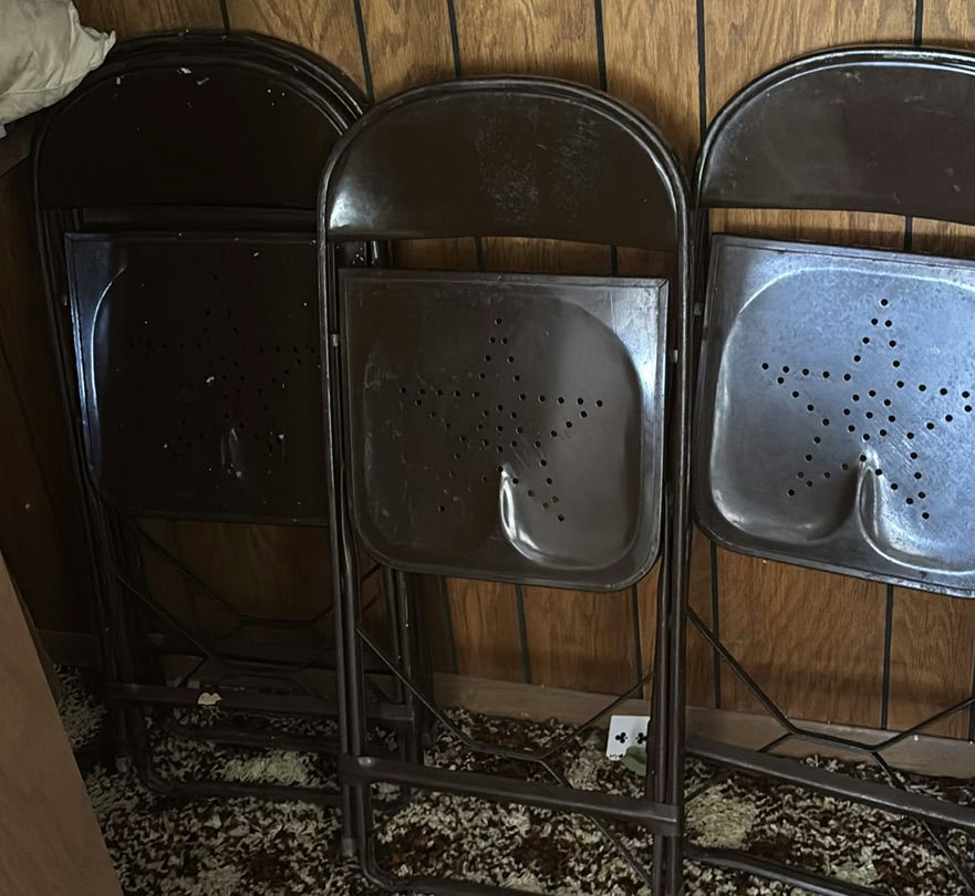 Stacked metal folding chairs - image 6 of 6