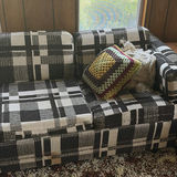 Plaid sleeper sofa with cushions and floral sheet - thumbnail 3 of 5