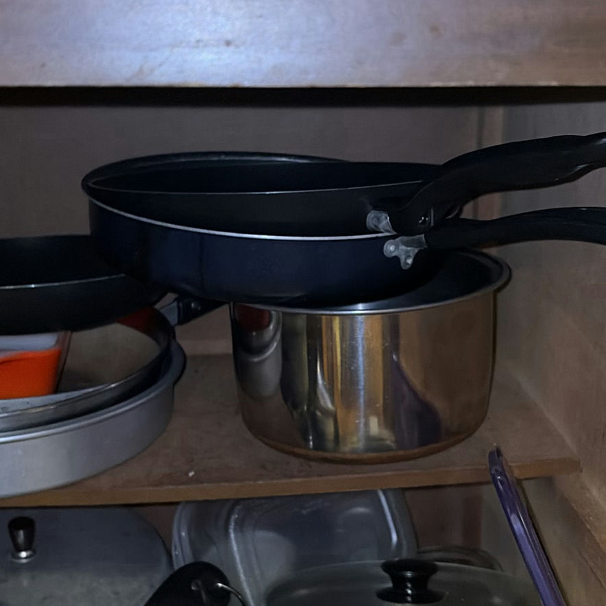 Assorted cookware and enamelware in a cabinet - image 4 of 10