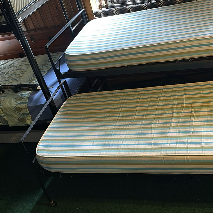 Metal bunk beds with striped mattresses - image 3 of 7