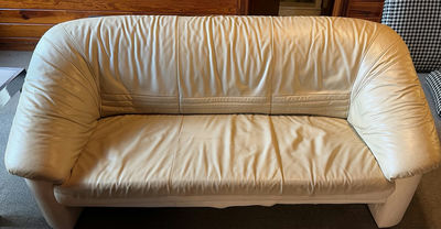 Beige leather sofa and love seat with blue and patterned throw pillows - Image 1 of 7