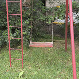 Red metal playground swing set with multiple swings and gym rings - thumbnail 3 of 5