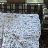 Plaid sleeper sofa with cushions and floral sheet - thumbnail 5 of 5