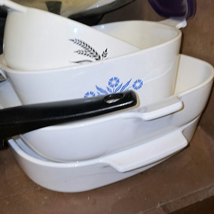 Assorted cookware and enamelware in a cabinet - image 9 of 10