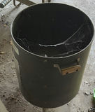 Stack of white plastic chairs and a black cylindrical metal trash can - thumbnail 3 of 4