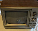 Vintage GE wood-veneer CRT television with two VTech handheld devices - thumbnail 2 of 6