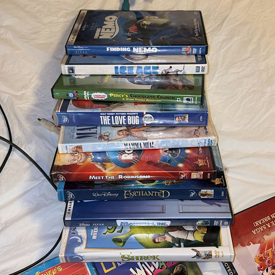 Sony DVD player with remotes and mixed DVD collection - image 5 of 6