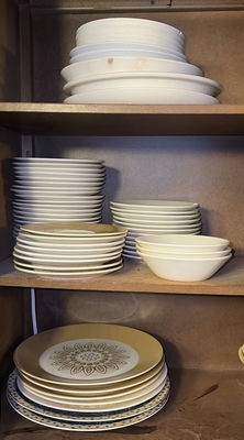 Stacked ceramic dinnerware (plates and bowls) - Image 1 of 4