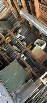 Cluttered shed with microwave, cabinets, screens and miscellaneous hardware - Image 1 of 7