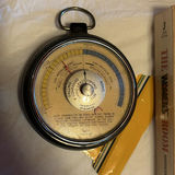 Assorted items: carved wooden mask, barometer, books, glasses, lighter, cushions, ball and circular object - thumbnail 3 of 8